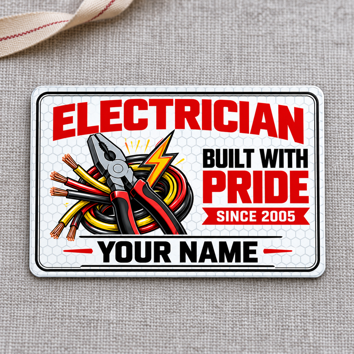 Electrician Honeycomb Pride aluminum wallet card on gray woven cloth