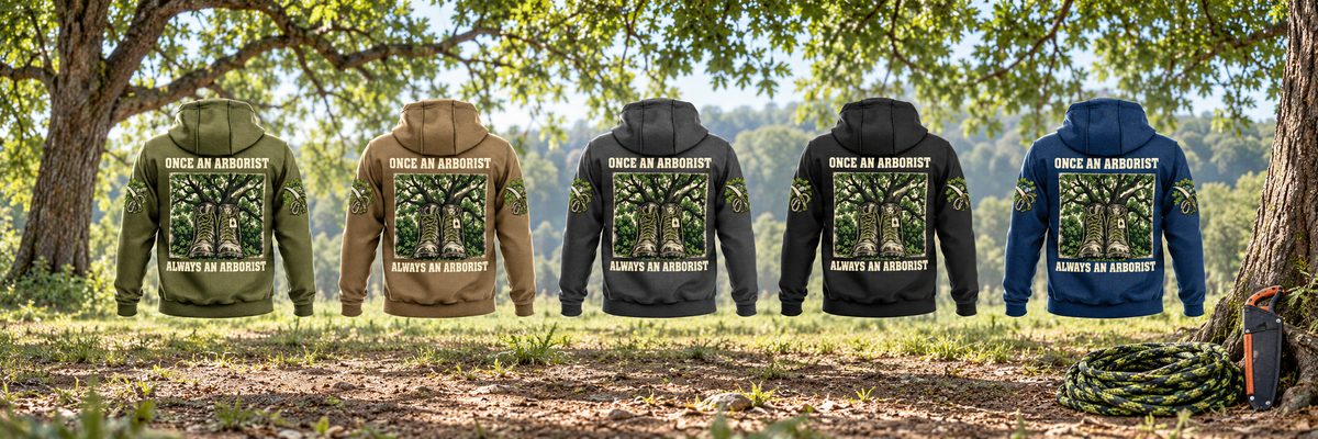 Five separate Arborist Once and Always Vintage Hoodie back views in Military Green, Kaki, Dark Gray, Black and Dark Blue beneath living tree canopy, with coiled climbing rope and a sheathed pruning saw resting nearby.