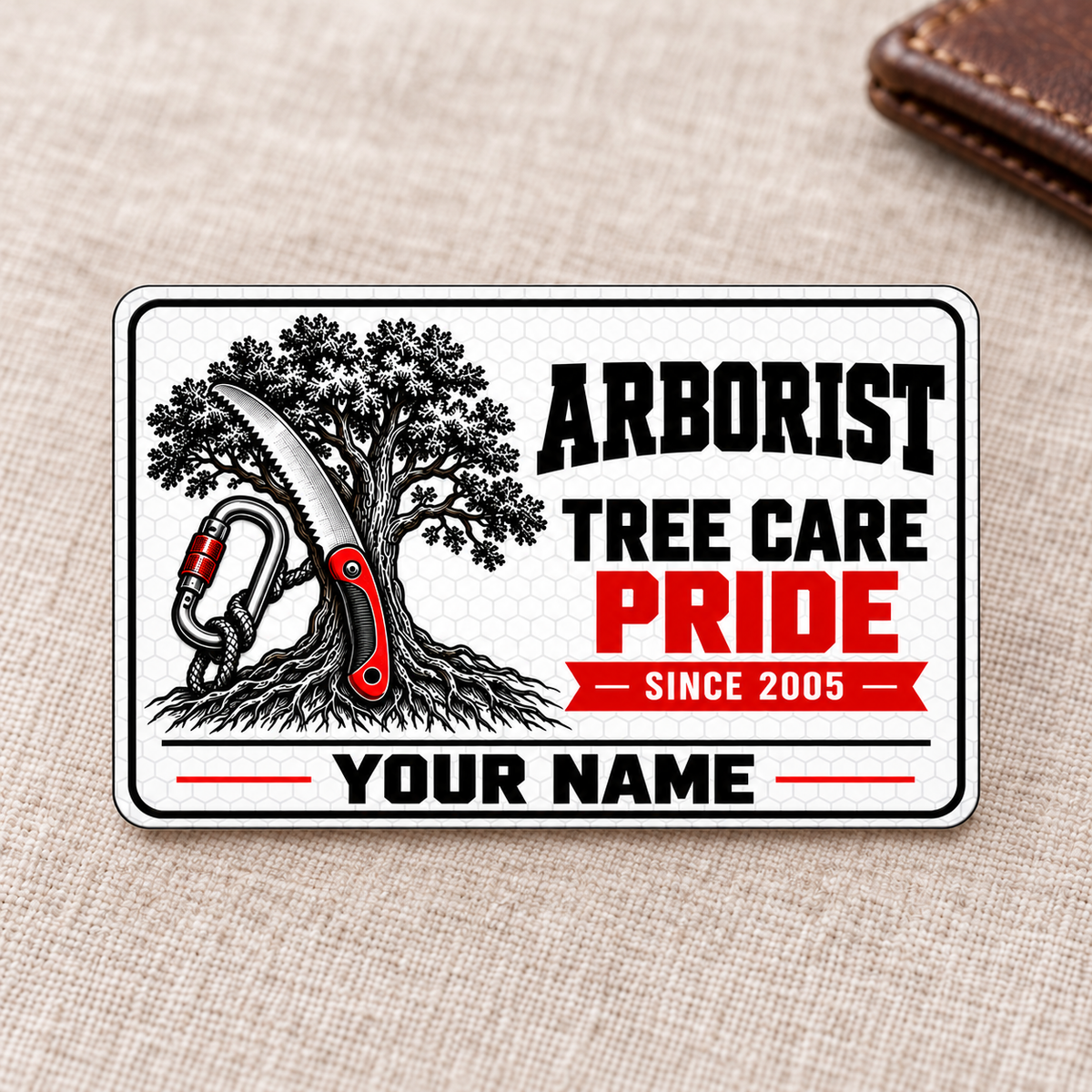 Front of the Arborist Honeycomb Pride aluminum wallet card on oatmeal linen.