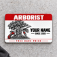 Front of the Arborist Red Header aluminum wallet card on light concrete.