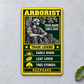 Arborist Trade Legend aluminum wallet card, portrait front view on pale concrete.