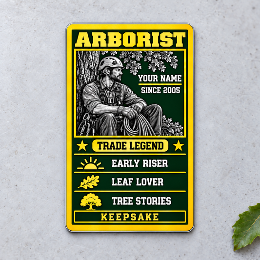 Arborist Trade Legend aluminum wallet card, portrait front view on pale concrete.