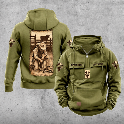 Bull Rider Daily Commitment Portrait Vintage Hoodie in Military Green, front and back views with sample text CUSTOM NAME and SINCE 2000, small sleeve motifs and a tall sepia kneeling rider illustration.