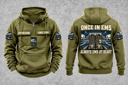 EMS Once and Always Vintage Hoodie in Military Green, separate front and back views with CUSTOM NAME and SINCE 2000 chest text, generic ambulance and response-bag motifs, and framed duty-boots artwork.