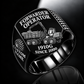 John Deere 1910G Forwarder Operator Ring in Black finish, flat engraving showing plain log grapple and loaded stake-sided timber bunk, CUSTOM NAME and SINCE 2000.