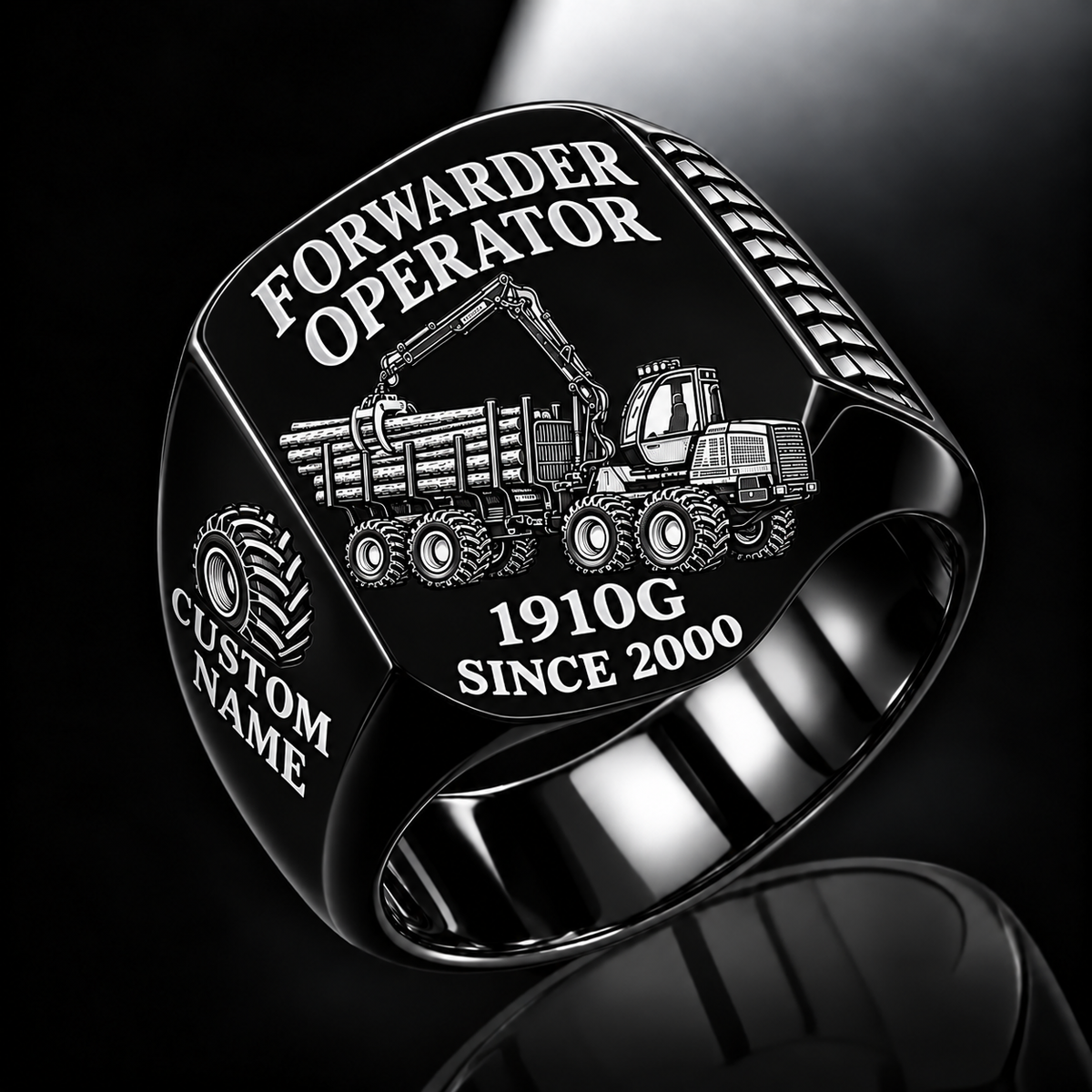 John Deere 1910G Forwarder Operator Ring in Black finish, flat engraving showing plain log grapple and loaded stake-sided timber bunk, CUSTOM NAME and SINCE 2000.