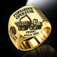 John Deere 1910G Forwarder Operator Ring in Gold finish, flat engraving showing plain log grapple and loaded stake-sided timber bunk, CUSTOM NAME and SINCE 2000.