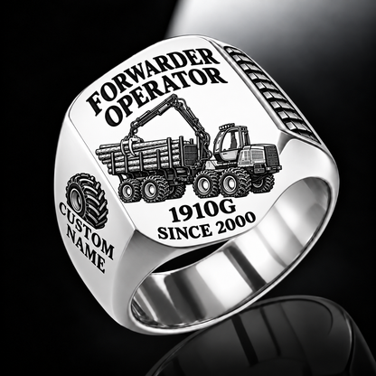 John Deere 1910G Forwarder Operator Ring in Silver finish, flat engraving showing plain log grapple and loaded stake-sided timber bunk, CUSTOM NAME and SINCE 2000.