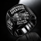 Komatsu 875 8WD Forwarder Operator Ring in Black finish, flat engraving showing plain log grapple and loaded stake-sided timber bunk, CUSTOM NAME and SINCE 2000.
