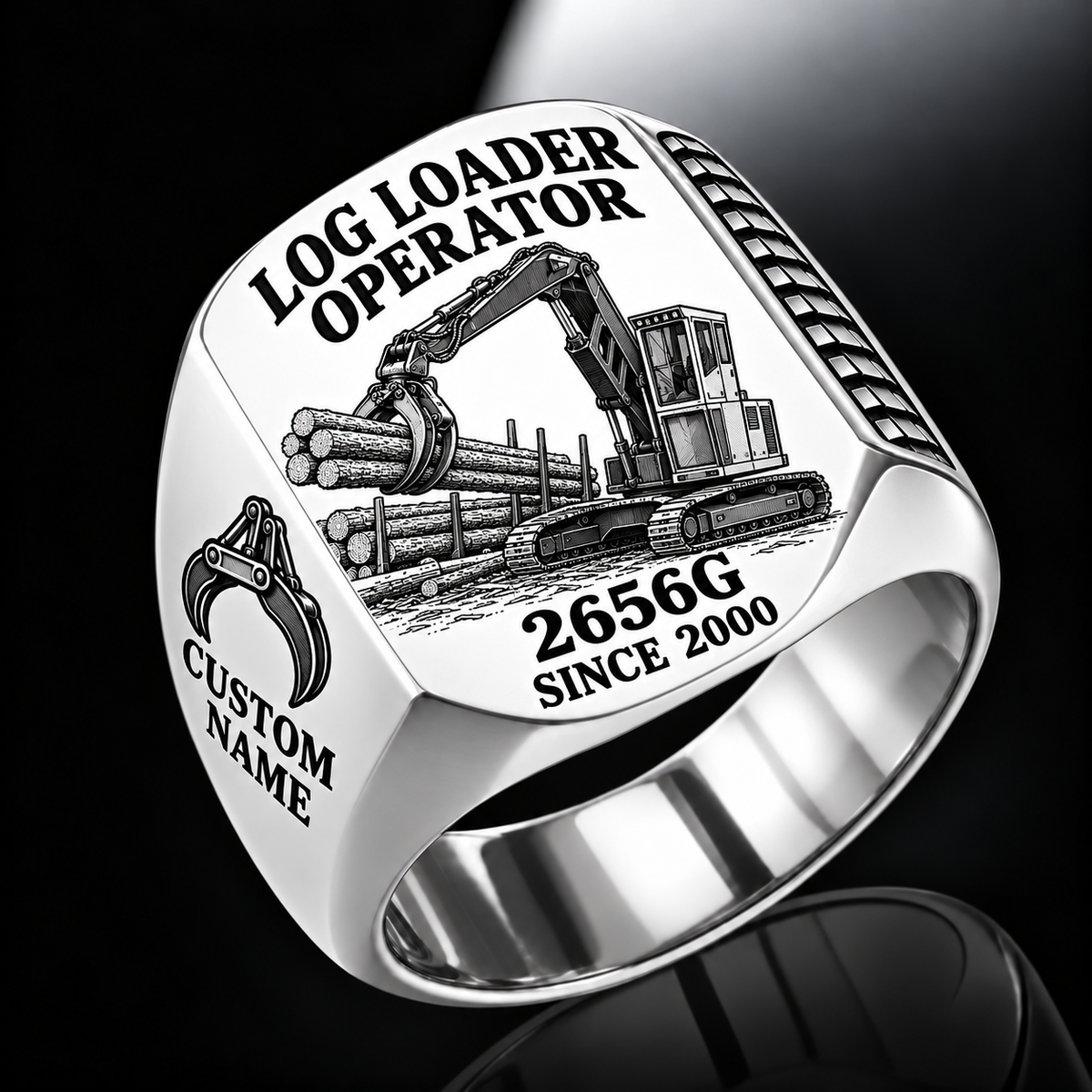John Deere 2656G Log Loader Operator Ring in Silver finish, flat engraving showing plain two-jaw log grapple on a loading boom, CUSTOM NAME and SINCE 2000.