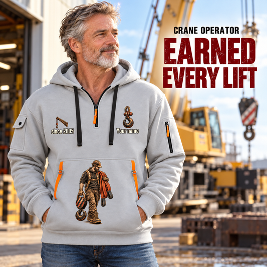 Crane Operator Earned Every Lift Quarter-Zip Hoodie in Light Grey, worn by an adult male model, preserving the current niche artwork, sample name and year, and hooded quarter-zip garment details.