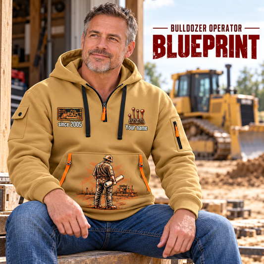 Bulldozer Operator Blueprint Quarter Zip Hoodie in Khaki, worn by an adult male model, preserving the current niche artwork, sample name and year, and hooded quarter-zip garment details.