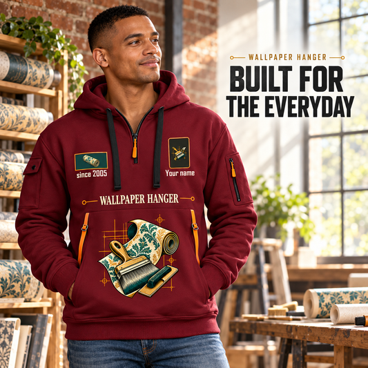 Wallpaper Hanger Built For The Everyday Quarter-Zip Hoodie in Wine Red, worn by an adult male model, preserving the current niche artwork, sample name and year, and hooded quarter-zip garment details.