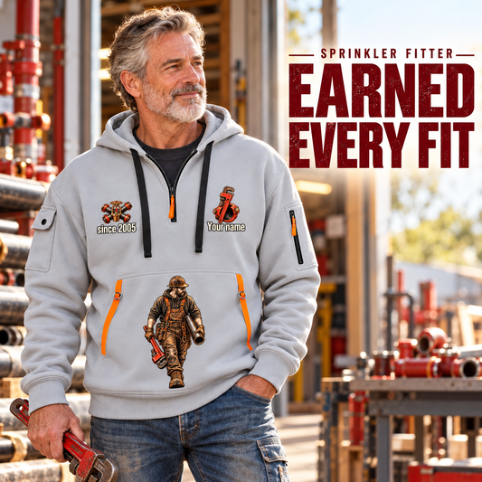 Sprinkler Fitter Earned Every Fit Quarter-Zip Hoodie in Light Grey, worn by an adult male model, preserving the current niche artwork, sample name and year, and hooded quarter-zip garment details.