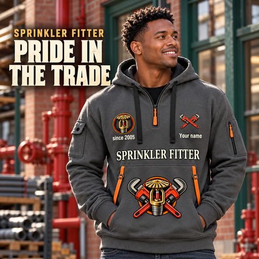 Sprinkler Fitter Pride in the Trade Quarter-Zip Hoodie in Gray, worn by an adult male model, preserving the current niche artwork, sample name and year, and hooded quarter-zip garment details.