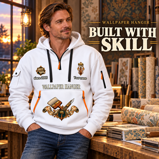 Wallpaper Hanger Built With Skill Quarter-Zip Hoodie in White, worn by an adult male model, preserving the current niche artwork, sample name and year, and hooded quarter-zip garment details.