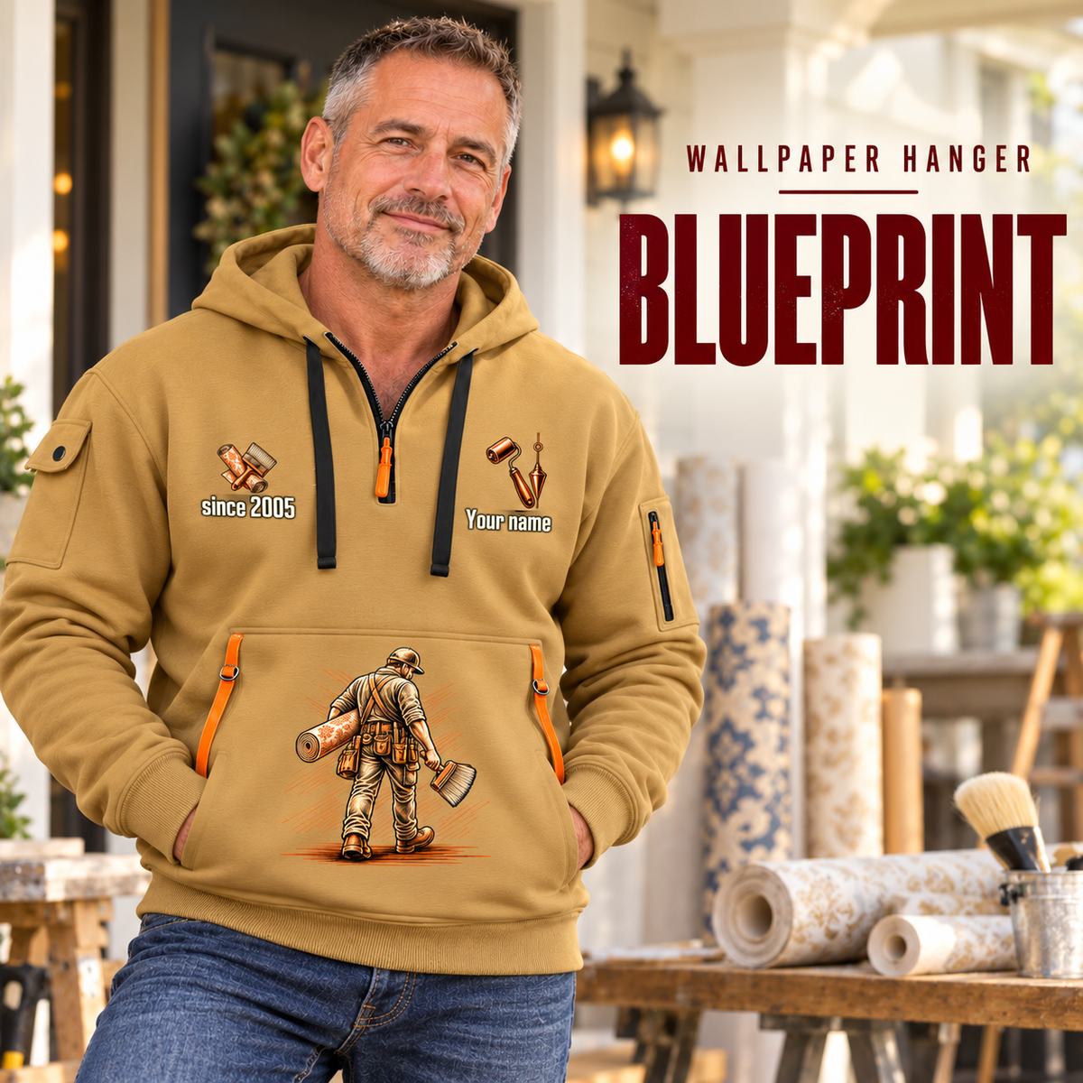 Wallpaper Hanger Blueprint Quarter-Zip Hoodie in Khaki, worn by an adult male model, preserving the current niche artwork, sample name and year, and hooded quarter-zip garment details.
