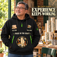 Wallpaper Hanger Experience Keeps Working Quarter-Zip Hoodie in Black, worn by an adult male model, preserving the current niche artwork, sample name and year, and hooded quarter-zip garment details.