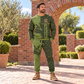 Adult model wearing Olive Bricklayer sweater and matching joggers in a brick courtyard