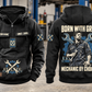 Mechanic By Choice Vintage Hoodie in Black, complete front and back views with sample text CUSTOM NAME and SINCE 2000, mechanic portrait, crossed wrenches, gear and socket-rail artwork in a quiet workshop.