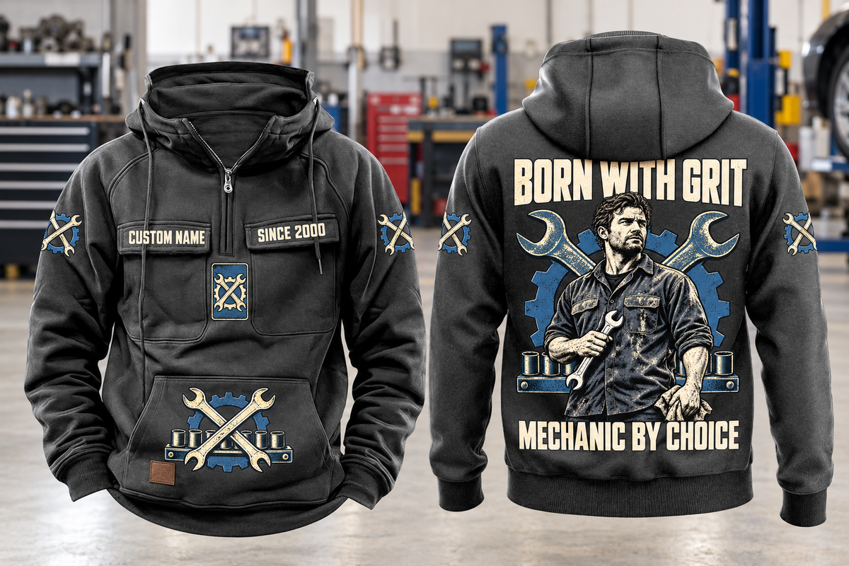 Mechanic By Choice Vintage Hoodie in Dark Gray, complete front and back views with sample text CUSTOM NAME and SINCE 2000, mechanic portrait, crossed wrenches, gear and socket-rail artwork in a quiet workshop.