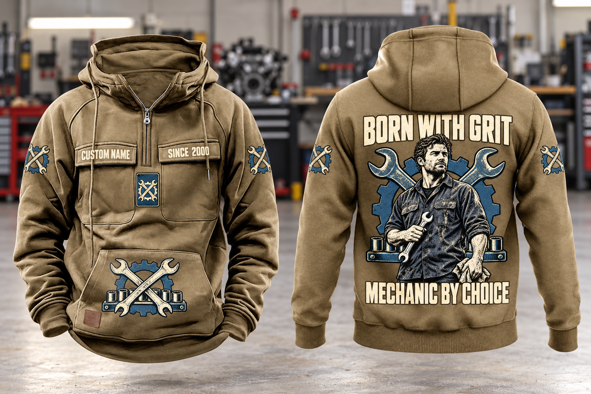 Mechanic By Choice Vintage Hoodie in Kaki, complete front and back views with sample text CUSTOM NAME and SINCE 2000, mechanic portrait, crossed wrenches, gear and socket-rail artwork in a quiet workshop.