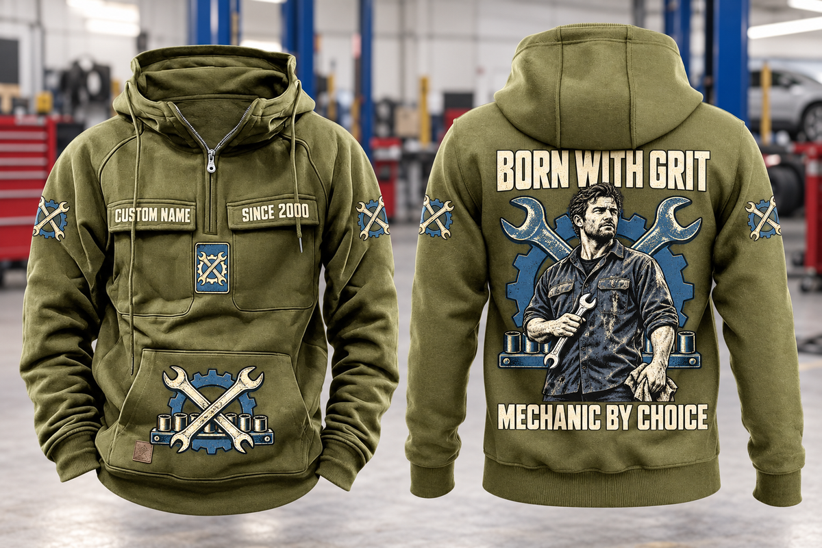 Mechanic By Choice Vintage Hoodie in Military Green, complete front and back views with sample text CUSTOM NAME and SINCE 2000, mechanic portrait, crossed wrenches, gear and socket-rail artwork in a quiet workshop.