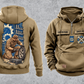 Mechanic Workday Portrait Vintage Hoodie in Kaki, separated front and back views with CUSTOM NAME and SINCE 2000 sample chest text, wrench-and-gear chest emblems, and a kneeling mechanic with wheel and closed tool case on a tall back panel.