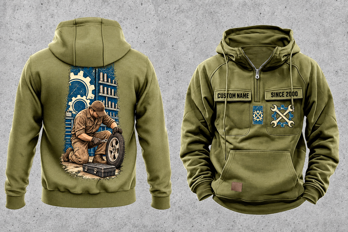 Mechanic Workday Portrait Vintage Hoodie in Military Green, separated front and back views with CUSTOM NAME and SINCE 2000 sample chest text, wrench-and-gear chest emblems, and a kneeling mechanic with wheel and closed tool case on a tall back panel.