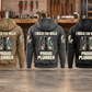 Five complete back views of the Plumber Proud Walk Vintage Hoodie in Military Green, Kaki, Dark Gray, Black and Dark Blue, arranged separately in front of an organized plumbing workbench.