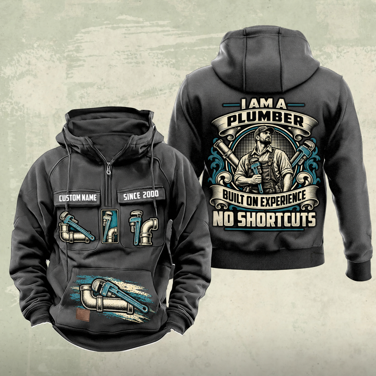 Plumber Heritage Crest Vintage Hoodie in Dark Gray, front and back views with cream and muted teal plumbing artwork and sample chest text CUSTOM NAME and SINCE 2000.