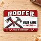 Front of the Roofer Red Header Pride aluminum wallet card on a subtle tabletop.