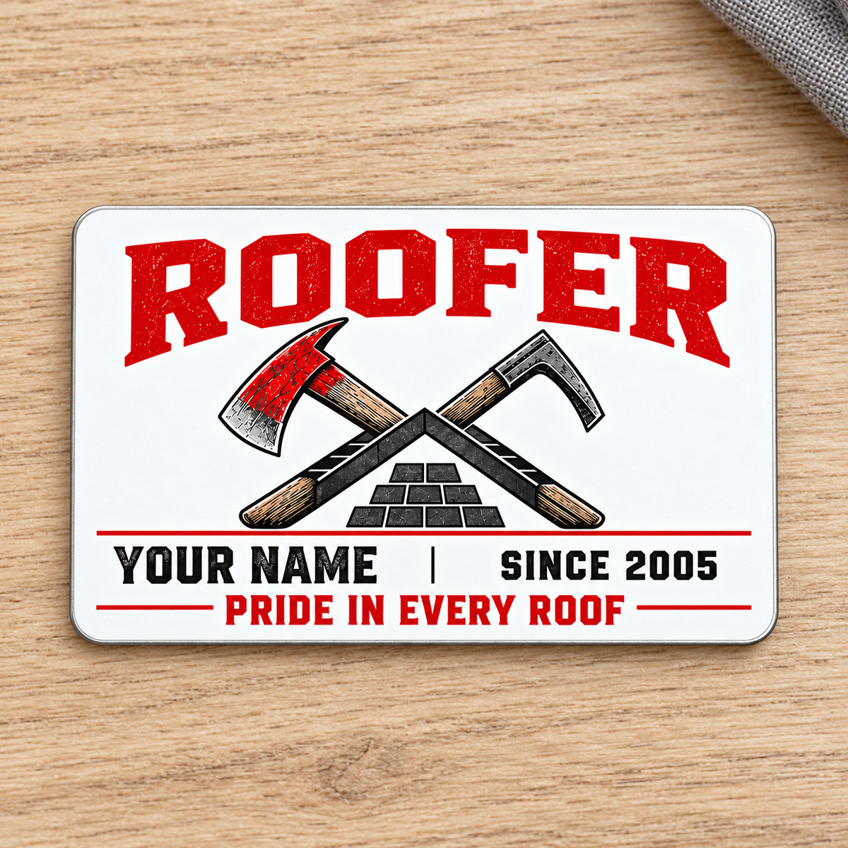 Front of the Roofer Minimal Tool Grid aluminum wallet card on a subtle tabletop.