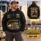 Trucker wearing Miles of Experience quarter-zip hoodie in their workplace; product introduction and shopping call to action