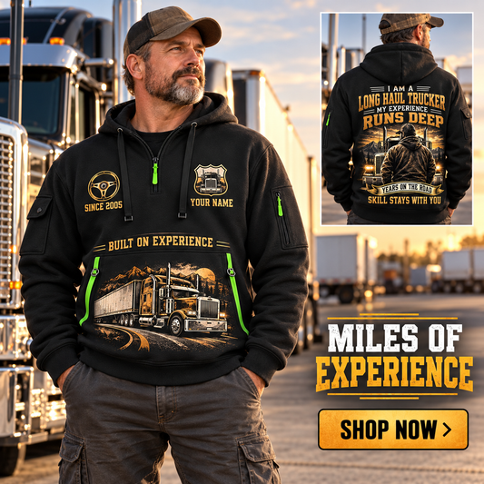 Trucker wearing Miles of Experience quarter-zip hoodie in their workplace; product introduction and shopping call to action