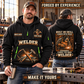 Welder wearing Forged with Pride quarter-zip hoodie in their workplace; product introduction and shopping call to action