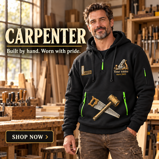 Carpenter wearing the Built by Hand quarter-zip hoodie in a woodworking workshop; Shop Now