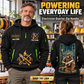 Electrician wearing Powering Everyday Life quarter-zip hoodie in their workplace; product introduction and shopping call to action