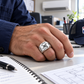 Silver HVAC Classic Emblem ring worn in an off-duty lifestyle setting