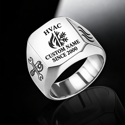 Silver HVAC Signature Crest signet ring featuring a combined flame-and-snowflake crest, airflow shoulder details and a face-centered name-and-year layout, with illustrative CUSTOM NAME and SINCE 2000
