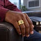 Gold HVAC Heritage Emblem ring worn in an off-duty lifestyle setting