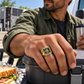 Gold HVAC Black Face Badge ring worn in an off-duty lifestyle setting