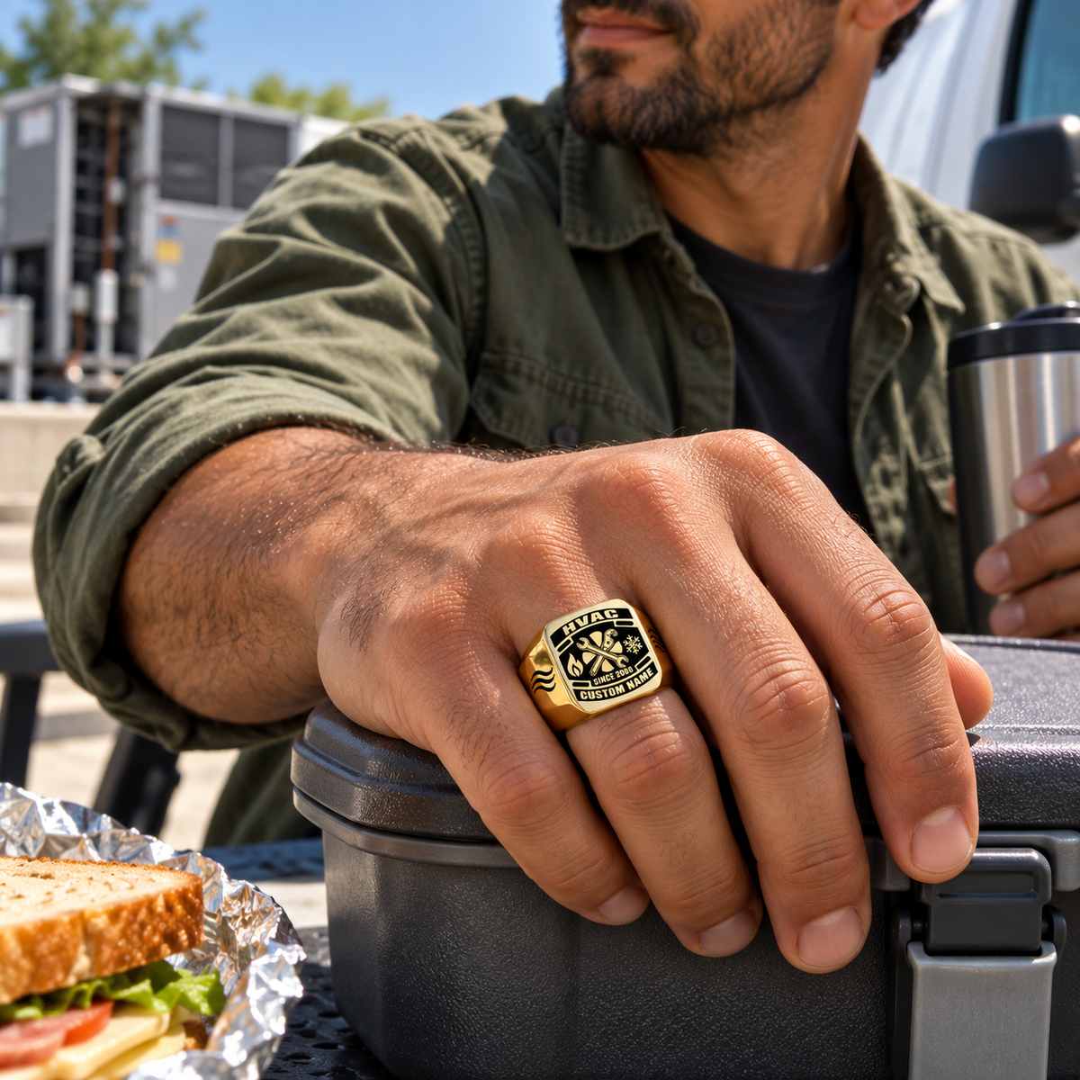 Gold HVAC Black Face Badge ring worn in an off-duty lifestyle setting