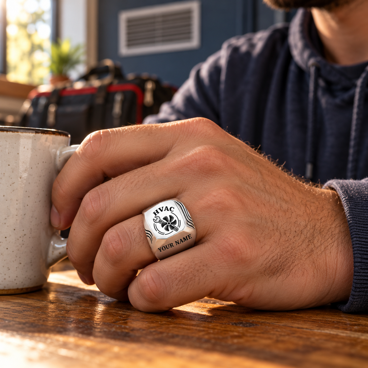 Silver HVAC Classic Emblem ring worn during an off-duty break