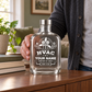 Empty metal-lid HVAC milestone bottle displayed on a home sideboard