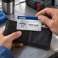 HVAC signature stripe wallet card being placed into a wallet at a service-van break table
