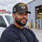 Personalized HVAC Carbon Stripe Baseball Cap worn by an adult HVAC technician during a break