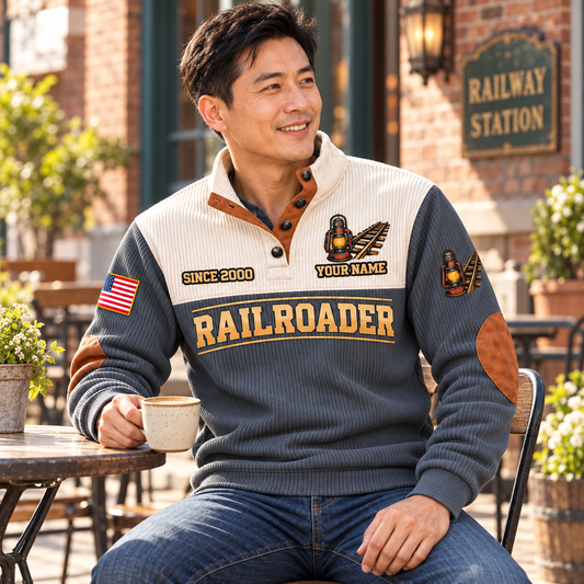Personalized Railroader Shift Finished Sports Sweatshirt — Grey, lean adult man with short black hair, seated front three-quarter at an outdoor heritage-station cafe