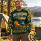 An adult at a quiet lakeside campsite wearing the Railroader Camp Lantern crewneck