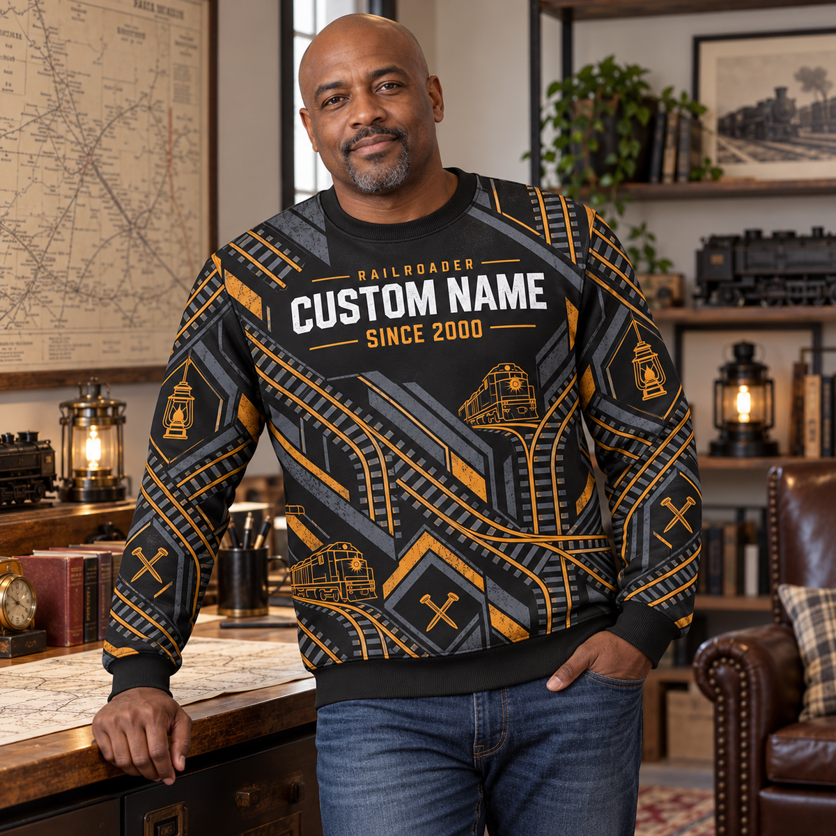 Adult beside an archival railway-map desk wearing Railroader Track Rhythm crewneck